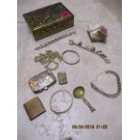 A silver charm bracelet with mixed charms, a silver cigarette box, costume jewellery, a quantity