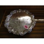 A Victorian silver plated salver with a cast and applied, scrolled border and engraved foliage