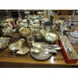 A quantity of silver plated items to include candlesticks and a silver rimmed dressing table pot