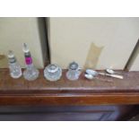 A small selection of silver topped scent bottles and spoons