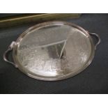 A late Victorian silver plated oval tray with twin handles and engraved fern ornament