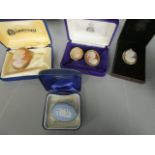 A group of four Edwardian and later shell cameos, each carved with a profile bust of a young lady,