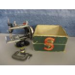 A miniature Singer sewing machine, with box