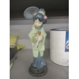 A Lladro figure of a Geisha girl with a parasol