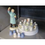 A collection of thimbles, together with a Royal Worcester figure entitled February