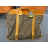 A Louis Vuitton suit carrier