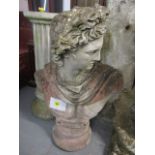 A concrete garden stoneware bust of Apollo on a fluted, column base