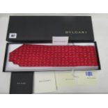 A Bvlari Italian silk red ground tie, boxed with certificates of authenticity, as new