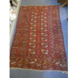 A Middle Eastern Bokhara red ground rug having geometric designs, 68" x 45"