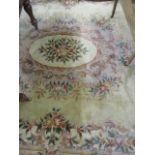 A large Chinese cream ground rug having floral decoration and tasselled ends, 148" x 109"