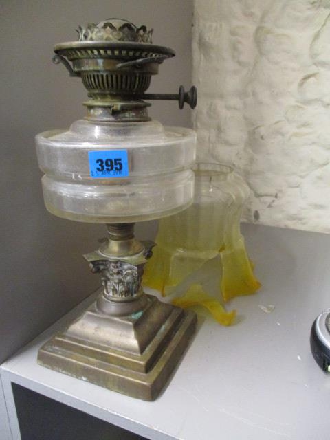 A Victorian Hinks brass oil lamp with clear cut glass reservoir and a Victorian floral etched