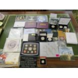 A selection of coins sets, commemorative coins and others to include a year 2000 five pound coin