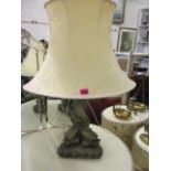 An early 20th century table lamp in the form of fish, together with a cream shade