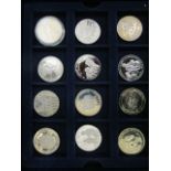 A selection of silver, silver gilt and enamelled commemorative coins to include Elizabeth and Philip