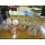 A selection of Victorian etched glass oil lamp shades, painted opal glass light shades and various