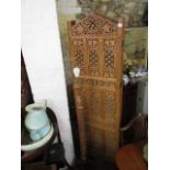 A modern profusely carved teak, four fold screen with brass inlaid and pierced ornament, 73" h,