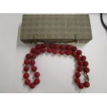 A Chinese red Cinnabar lacquered and carved, beaded necklace with filigree, silver gilt clasp, in