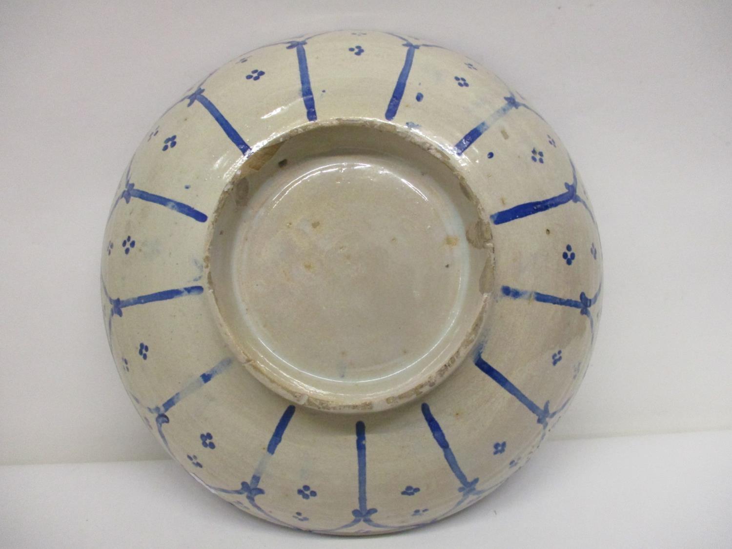 An early 20th century Islamic pottery bowl decorated with panels in blue and white, 13 1/4"dia - Image 3 of 4