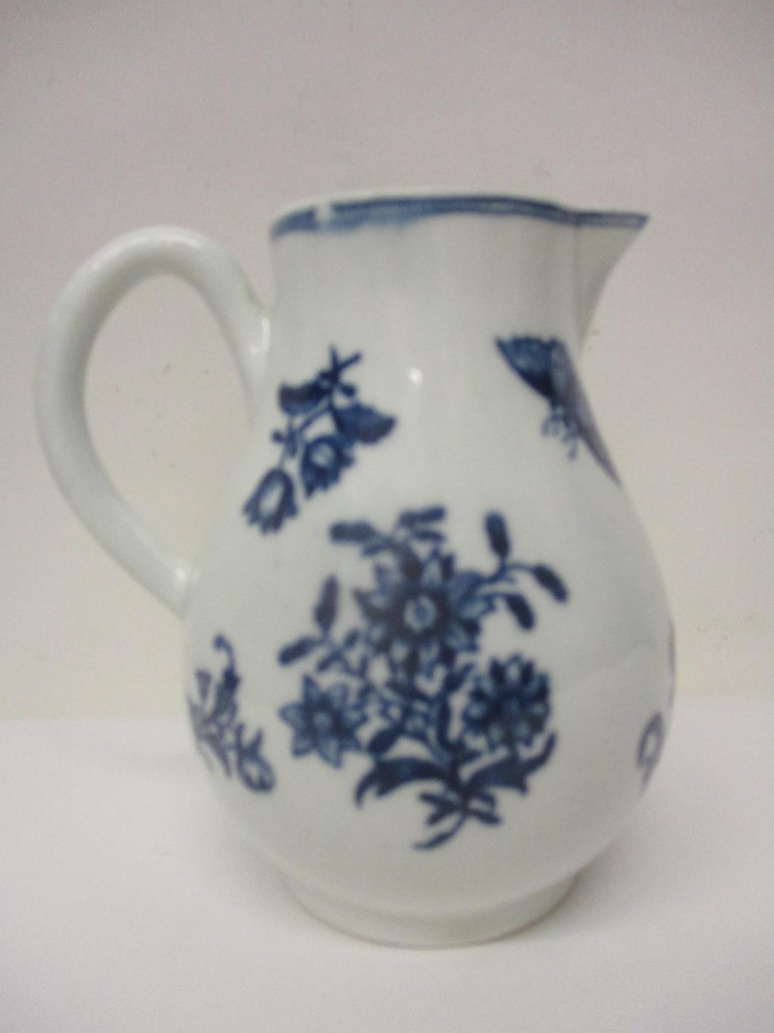 A late 18th century Worcester sparrow beak jug decorated with flowers and butterflies in blue and