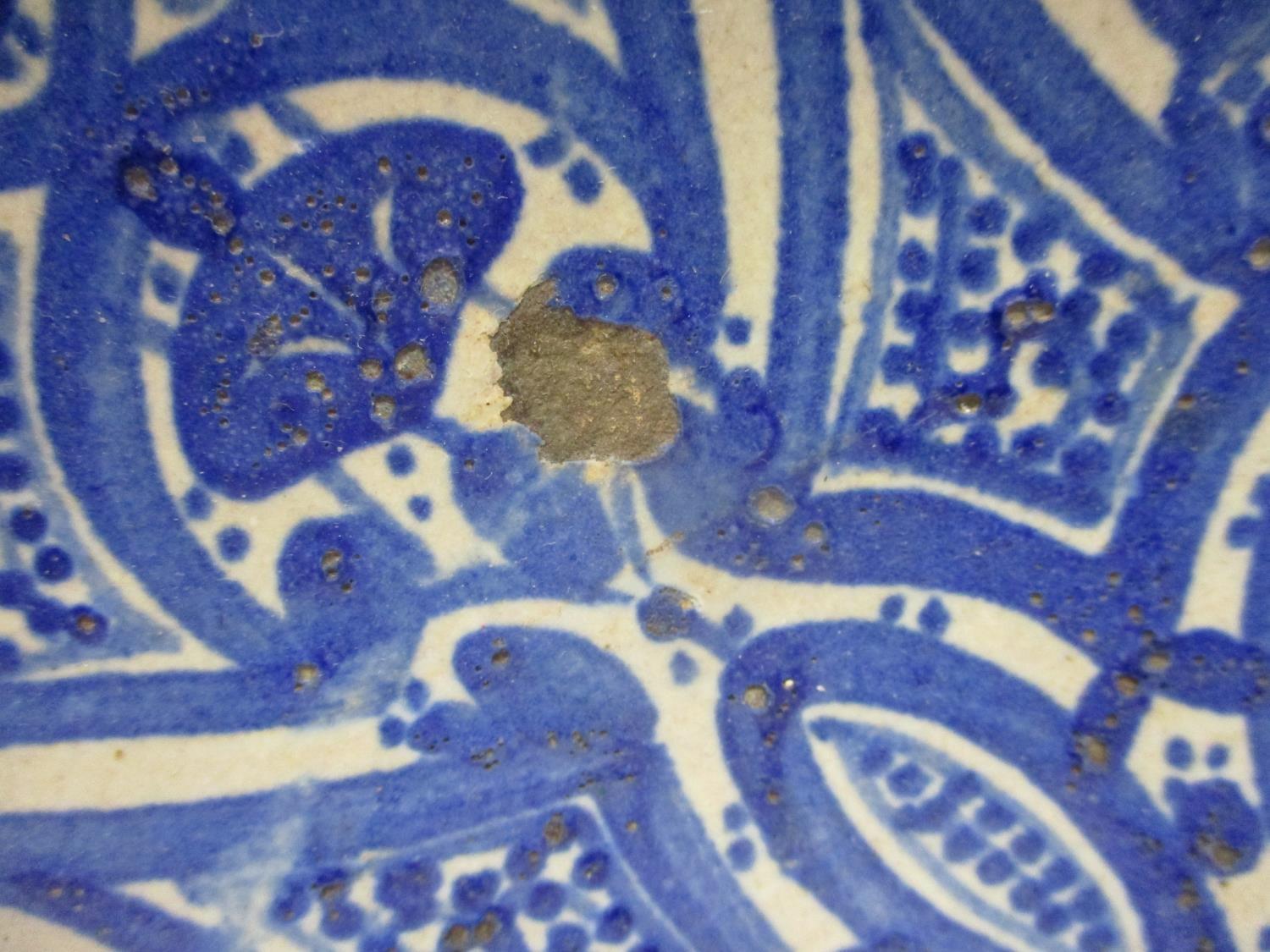 An early 20th century Islamic pottery bowl decorated with panels in blue and white, 13 1/4"dia - Image 2 of 4