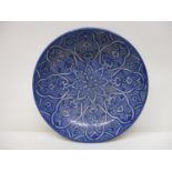 An early 20th century Islamic pottery bowl decorated with panels in blue and white, 13 1/4"dia