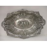 A late 19th century, possibly German oval dish with serpentine sides, decorated with flowers,