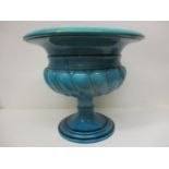 A Burmantoft Faience turquoise glazed Campania pedestal planter with gadrooned ornament on a