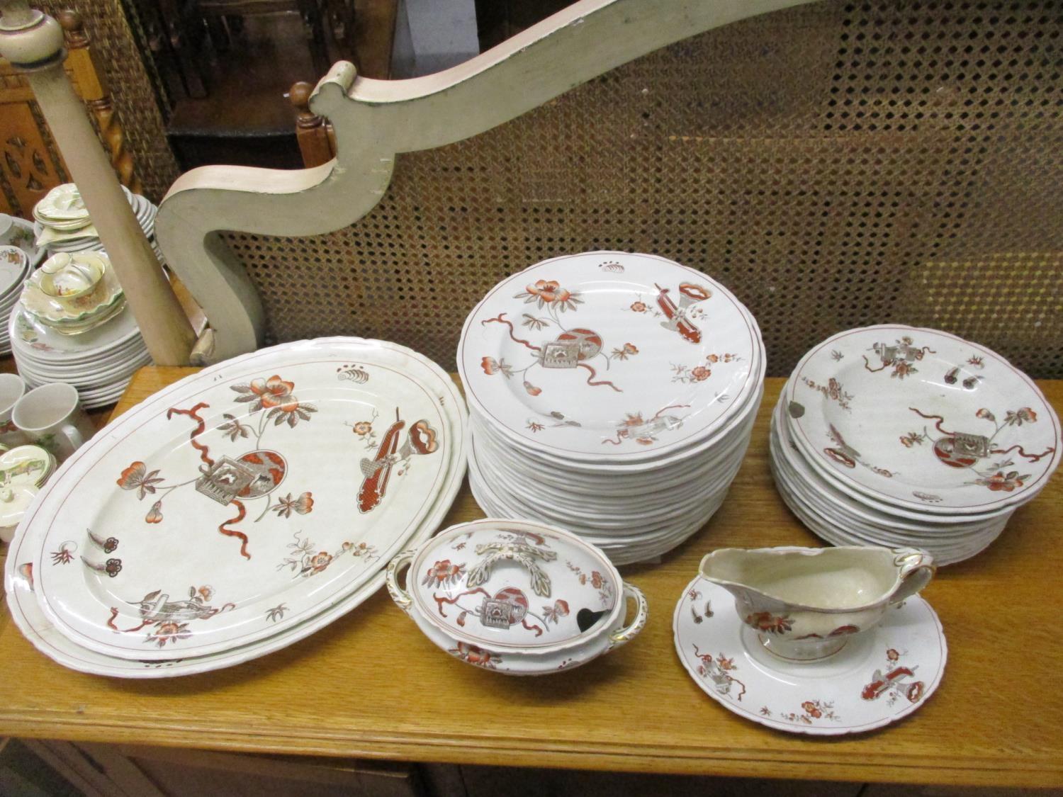 A Victorian Staffordshire part dinner service decorated with Oriental-inspired objects