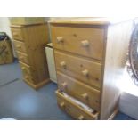 Two modern pine chest of drawers having bun shaped handles on plinth bases