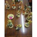 Ten Goebel figures designed by Hummel and a matching plate