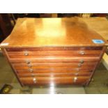 A wooden cased coin collectors cabinet with seven trays housing a collection of foreign and