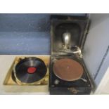 An early 20th century Decca Junior portable gramophone, together with mixed records