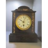 A Victorian black slate mantel clock having a white enamel dial and Roman numerals, 9 1/4"h x 7 1/