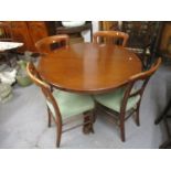 A Victorian mahogany dining table having an octagonal, tapered column, trefoil base and castors, 28"