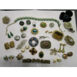 A mixed lot of costume jewellery to include a green paste and white stone cluster ring, clip on