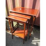 An Edwardian mahogany inlaid nest of three tables