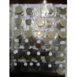 A coin album containing a selection of world coins, mainly silver to include a 1945 half crown, a