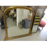 A reproduction gilt overmantle mirror, together with a rectangular wall mirror