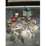 A selection of coins, tokens, medals, a cap badge and other items to include an Irvin enamel gilt