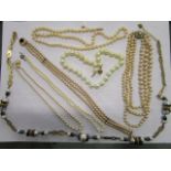 A quantity of costume jewellery to include a faux pearl necklace, some with silver clasps to include