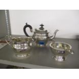 A silver three piece teaset comprising of a milk jug, a sugar bowl and a teapot