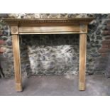 An Edwardian stripped pine fireplace surround