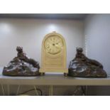 Two reproduction brass bookends in the form of tigers, together with a modern mantle clock