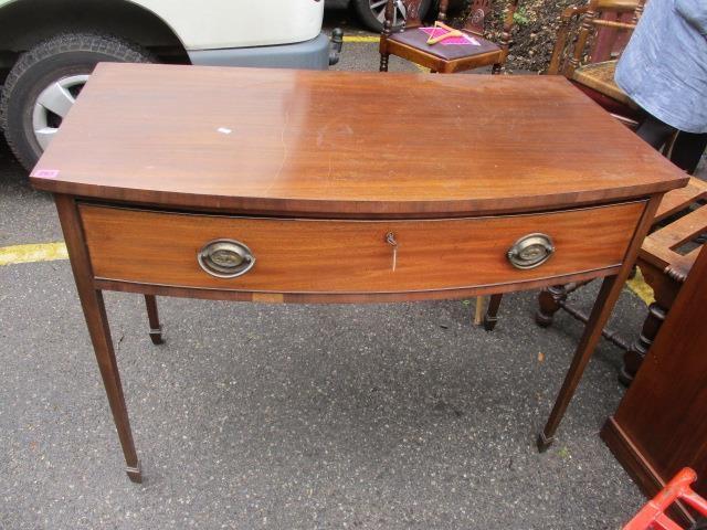 A Victorian mahogany bow fronted side table with single drawer, standing on square, tapering legs