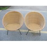 A pair of mid 20th century wicker satellite armchairs, on metal legs