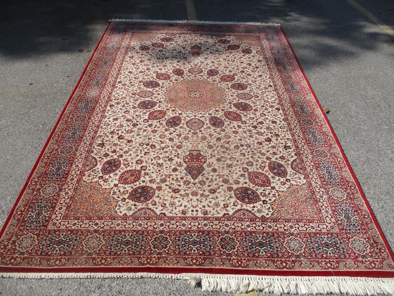 A Tehran machine made carpet with a central medallion and palmets on a cream ground, 122" x 79"