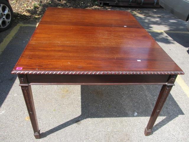 An early 20th century mahogany dining table on carved, square, tapering legs, 30" h x 53" w