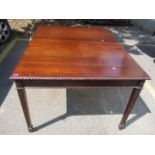 An early 20th century mahogany dining table on carved, square, tapering legs, 30" h x 53" w