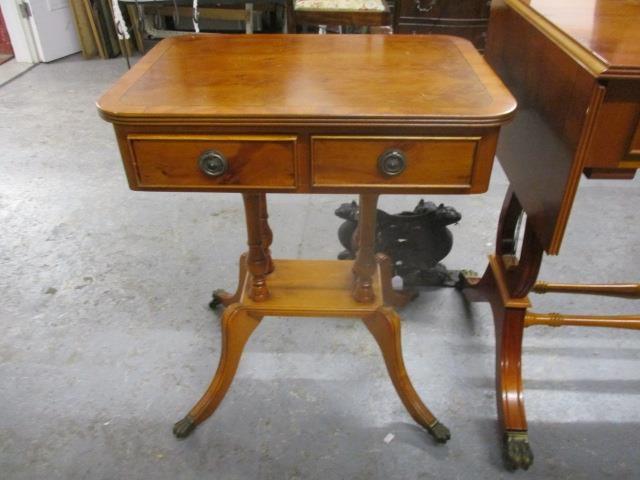 A modern yew pedestal, twin drawer lamp table, raised on splayed legs