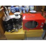 A Swan red cased microwave and a Morphy Richards coffee machine